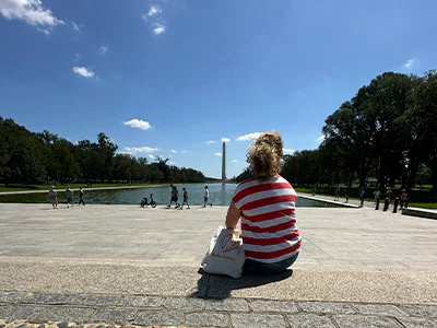 Bianca sitting in front of the Washington Monument in Washington