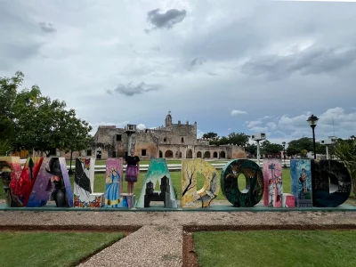 Chrismarie stands in front of a Valladolid sign in Mexico