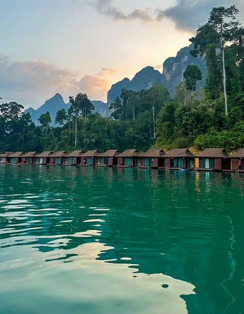 Floating bungalows on an emerald-green lake in Thailand