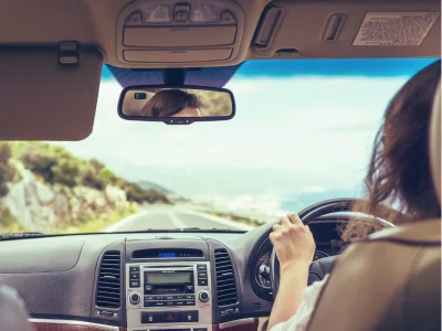 Woman driving on the left-hand side of the road in Australia