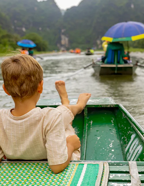 A child enjoying a boat trip in Ninh Binh, Vietnam