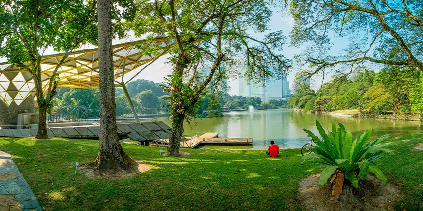 Man relaxing in the park at Perdana Botanical Gardens in Kuala Lumpur