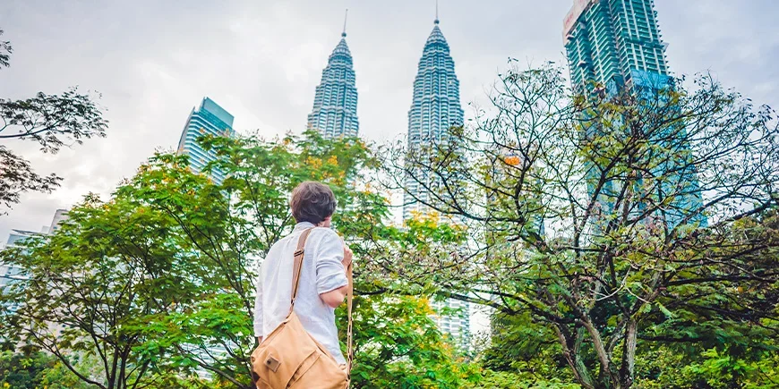 Man looking at the Petronas Twin Towers in Kuala Lumpur, Malaysia