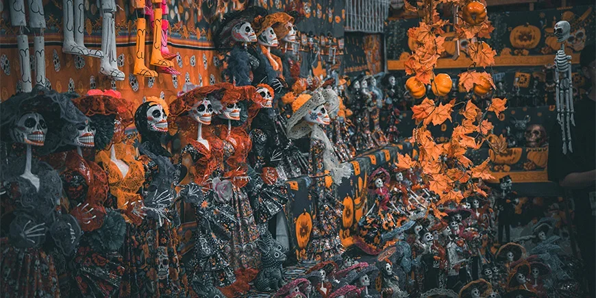 Exhibition featuring skeletons dressed in orange and black