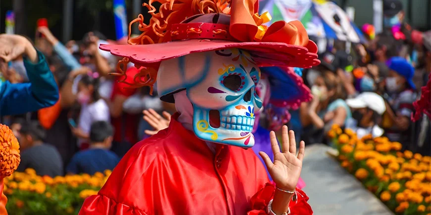 Person in costume at a Day of the Dead parade in Mexico