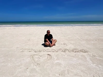 Tom sitting in the sand on Isla Holbox in Mexico