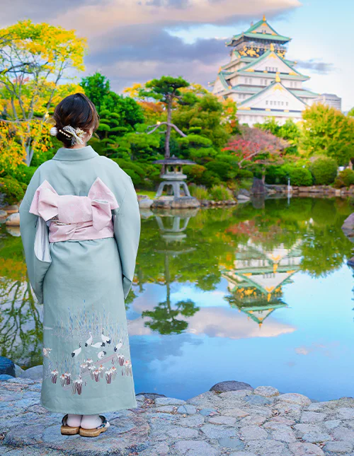Japanese woman in front of Osaka Castle