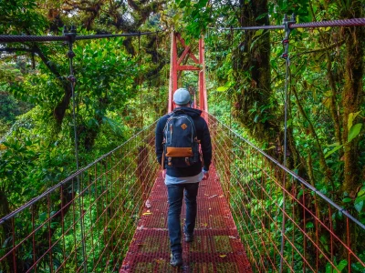 Man walking alone on a suspension bridge in Monteverde Cloud Forest in Costa Rica