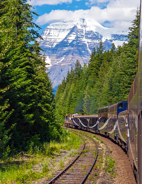 The summit of Mount Robson in summer seen from the Rocky Mountaineer train