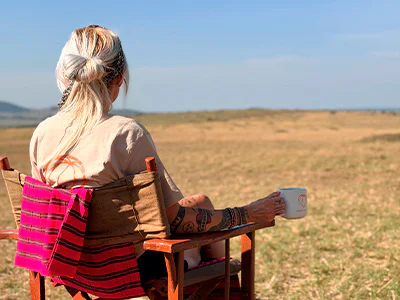 Cat drinks coffee on the savannah in Kenya