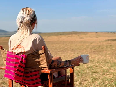 Cat drinks coffee on the savannah in Kenya