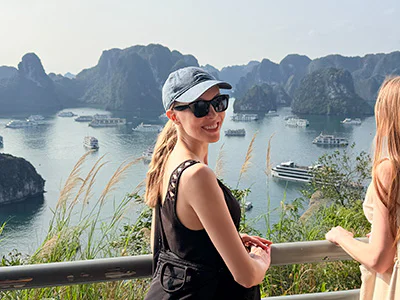 Iida looks into the camera with her back to Ha Long Bay