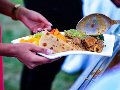 Woman holding a plate of food in Kenya