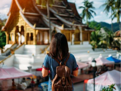A woman admires a temple in Luang Prabang, Laos