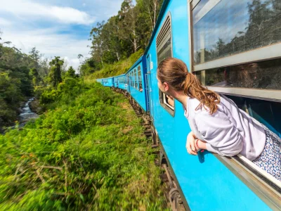 Woman looking out of a train window in Sri Lanka