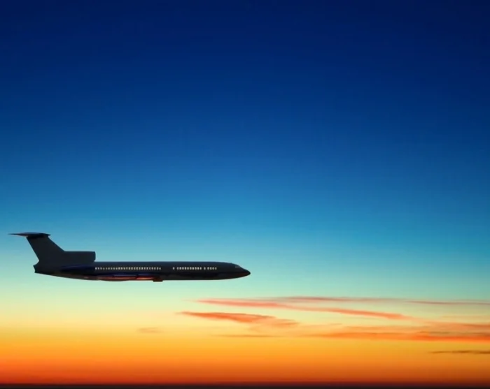 Plane in the sky at sunset