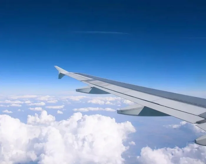 Aircraft wing above the clouds on the way to your destination