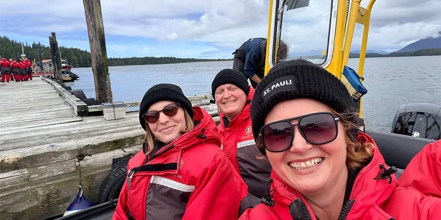 Bianca and two colleagues from TourCompass sitting in a boat on their way to go whale-watching in Canada
