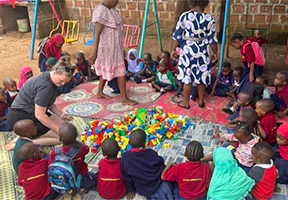 Pernille plays with Lego together with the children at Moshi Kids Center.
