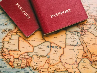 Two passports lie on a map of Africa