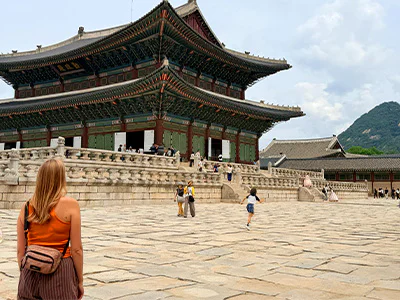 Woman looking at Gyeongbokgung Palace in Seoul