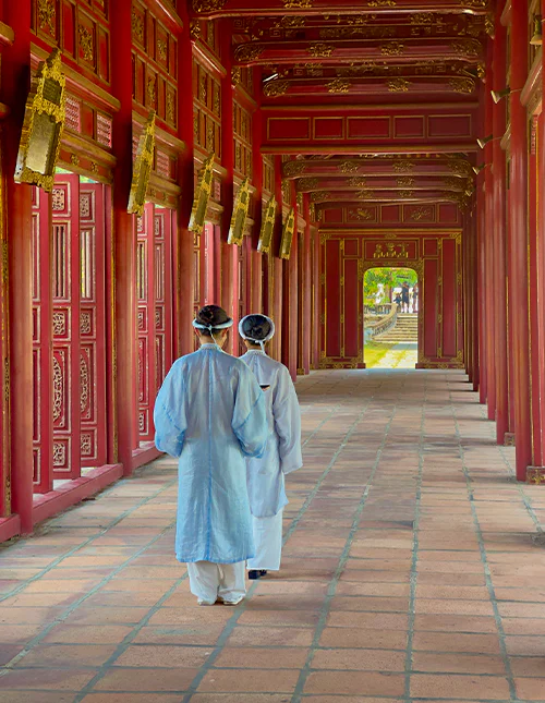 People in traditional attire in the ancient imperial city of Hué, Vietnam