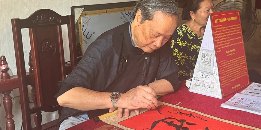 Vietnamese man doing calligraphy