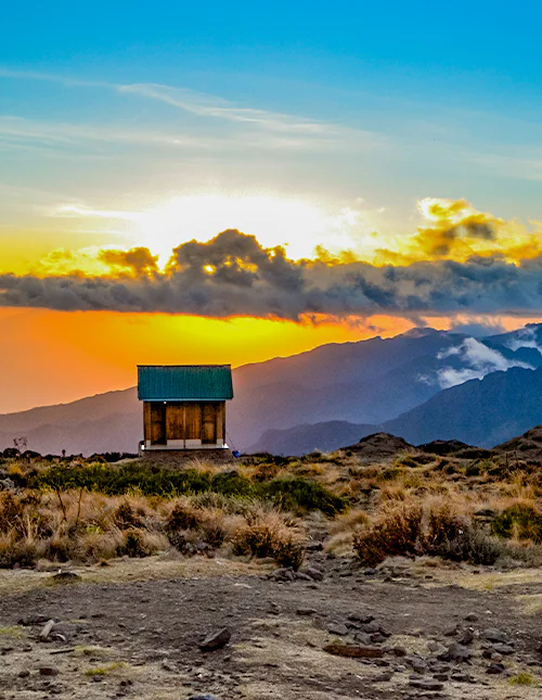 Small hut on the slopes of Kilimanjaro at sunset.