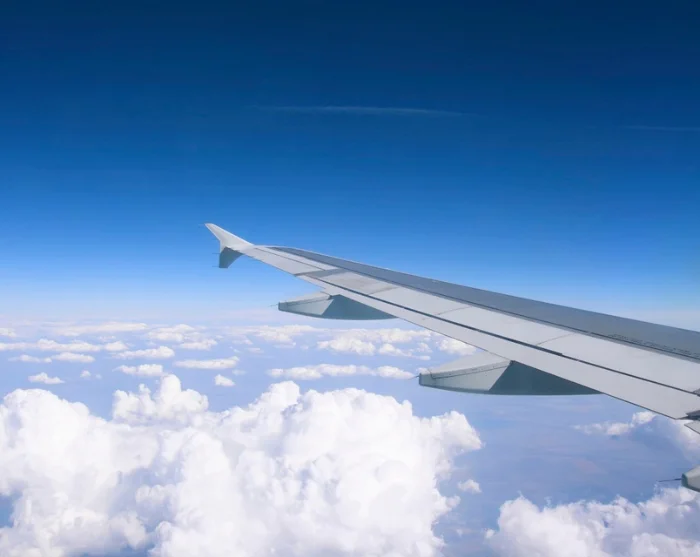 Aeroplane wing above the clouds on the way to the destination