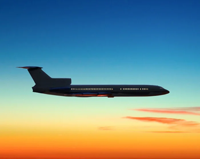 Plane in the sky at sunset