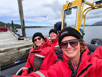 Bianca and two colleagues from TourCompass sitting in a boat heading out on a whale-watching trip in Canada