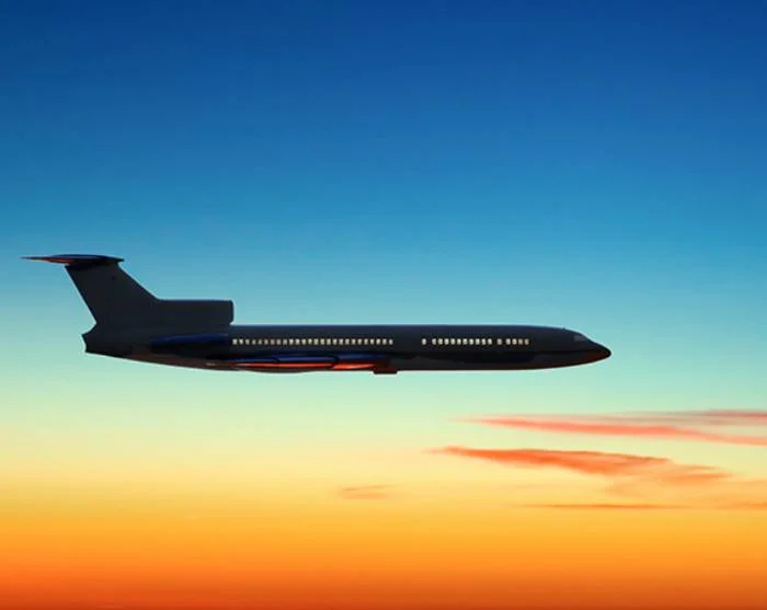 Plane in the sky at sunset