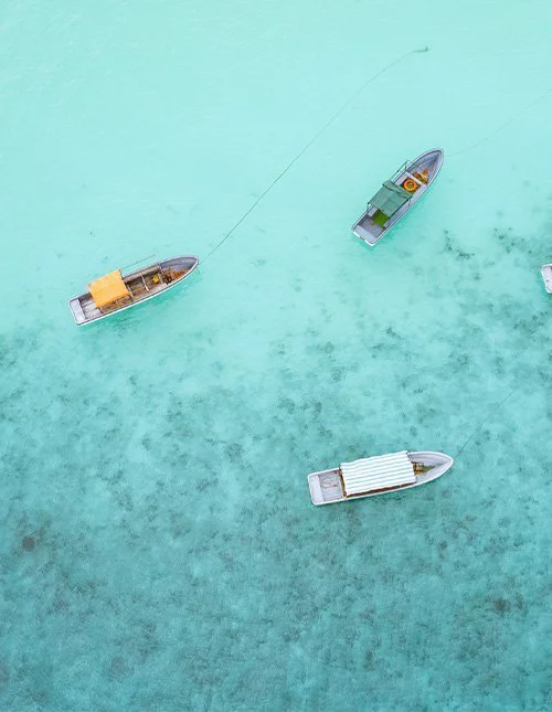 Small boats on shallow, turquoise waters
