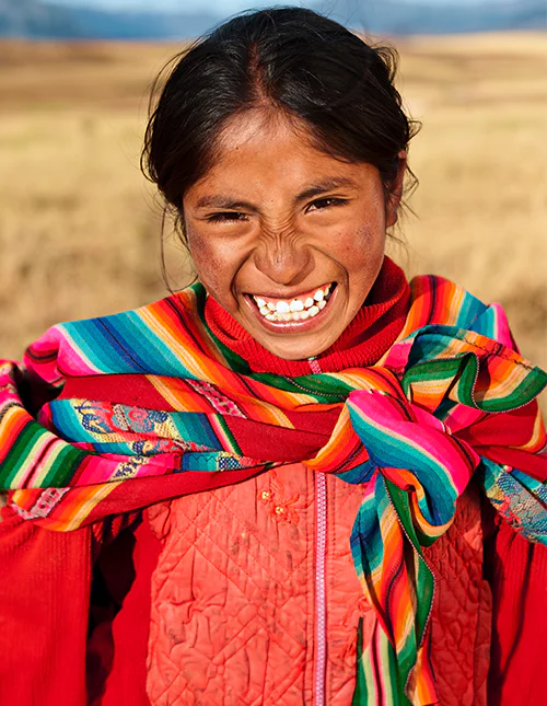 Smiling woman wearing a colourful shawl