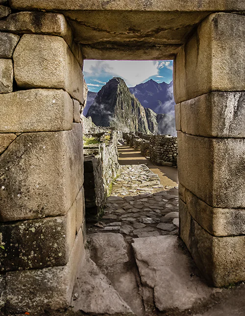 Stone gateway with views of Machu Picchu and the misty Andes.