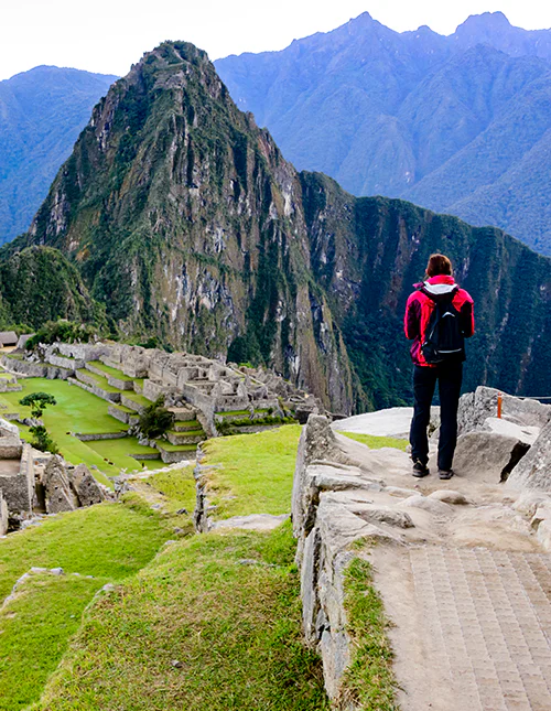 A person standing and looking out over Machu Picchu