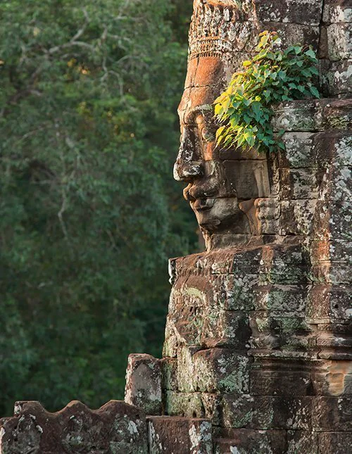 Face of Buddha stone carving at Bayon temple in Cambodia
