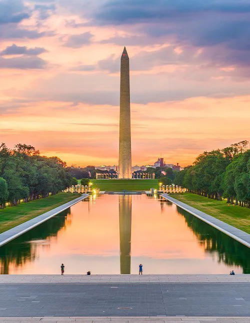 The Washington Monument by the Reflecting Pool in Washington, DC, USA at dawn.