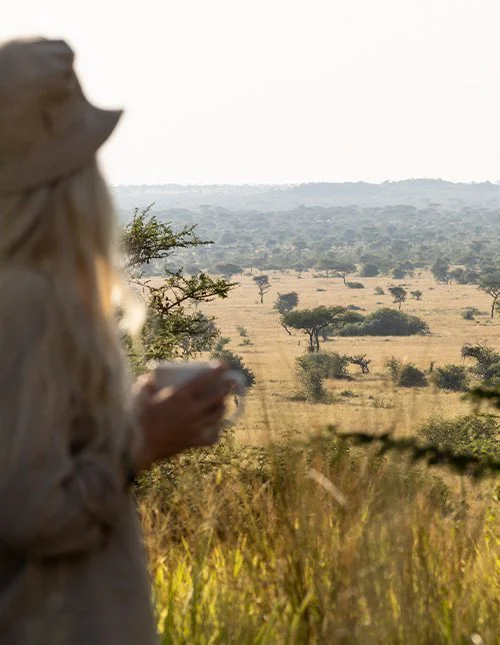 Woman looking out across the savannah landscape