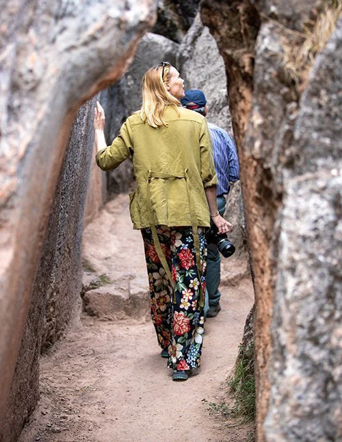 Hikers make their way through a narrow gorge between towering cliffs