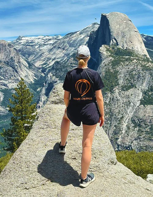 Person wearing a TourCompass T-shirt enjoying the mountain views in the USA