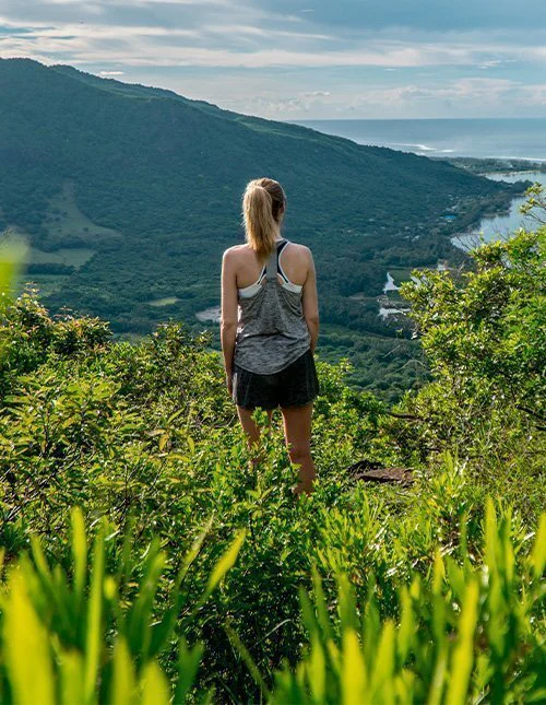 A woman looking out over Le Morne Brabant in Mauritius