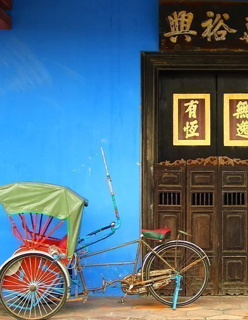 Chinese blue house door with rickshaw in Singapore